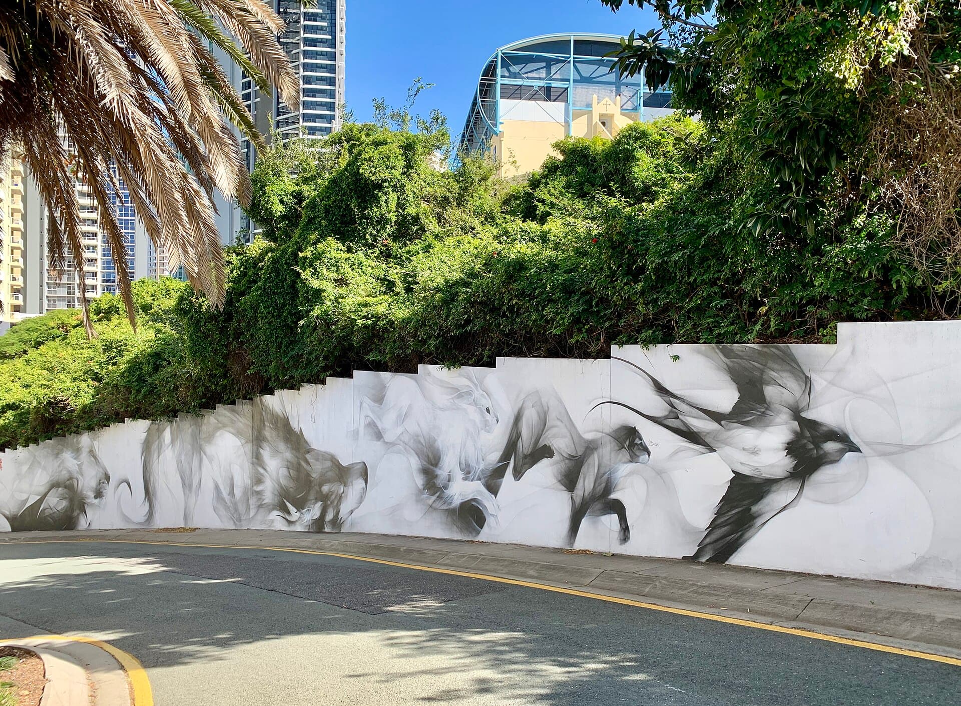 A high painted paling fence with a mural on Ivory Lane in inner Brisbane