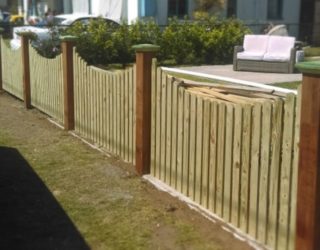 Dressed timber front fence paddle pop palings arched
