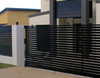 Powder coated aluminium slat sliding gate with rendered block wall and pillars